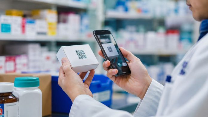 Pharmacy worker scanning medicine packaging